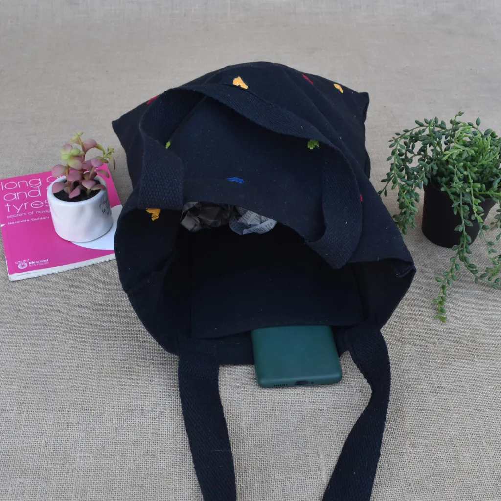Black canvas tote bag with small hearts embroidery